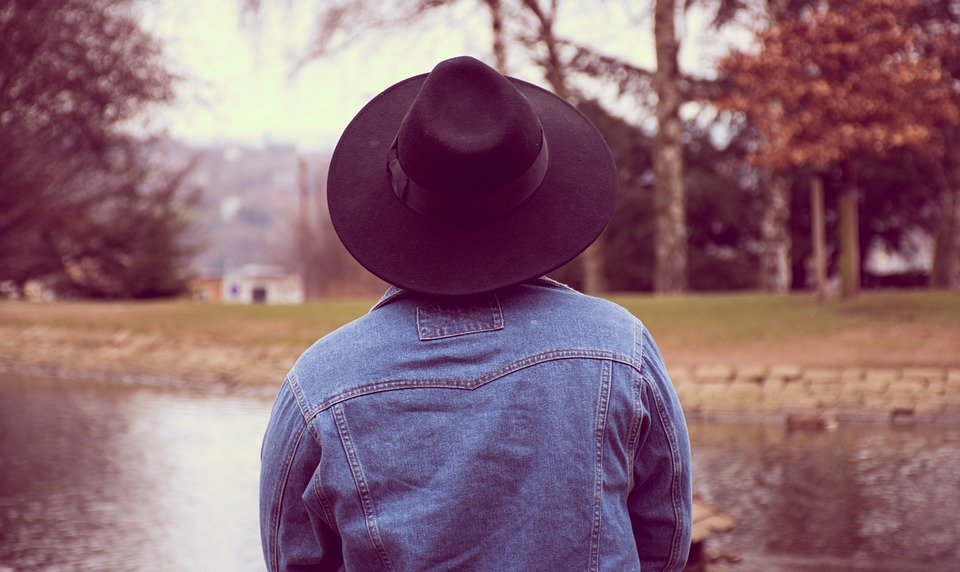 autumn day jean jacket black cowboy hat back profile